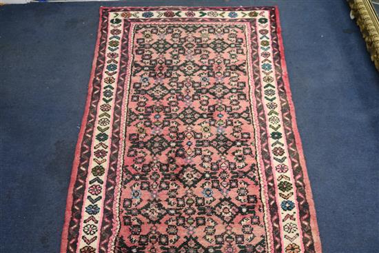 A Persian brick red ground runner, 950cm x 74cm